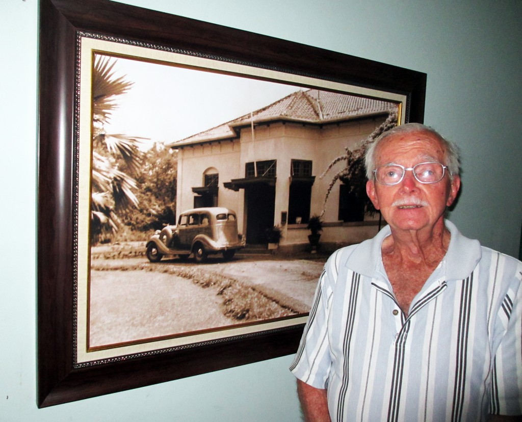 Neal Hobbs with photo of original Charitas Hospital for web
